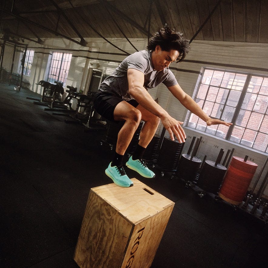 Man doing a box jump wearing that lagoon pear drive 2