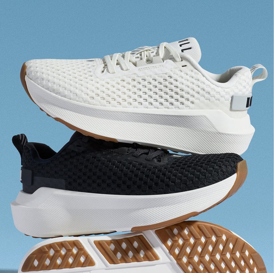 White, black, and brown athletic shoes stacked on a blue background