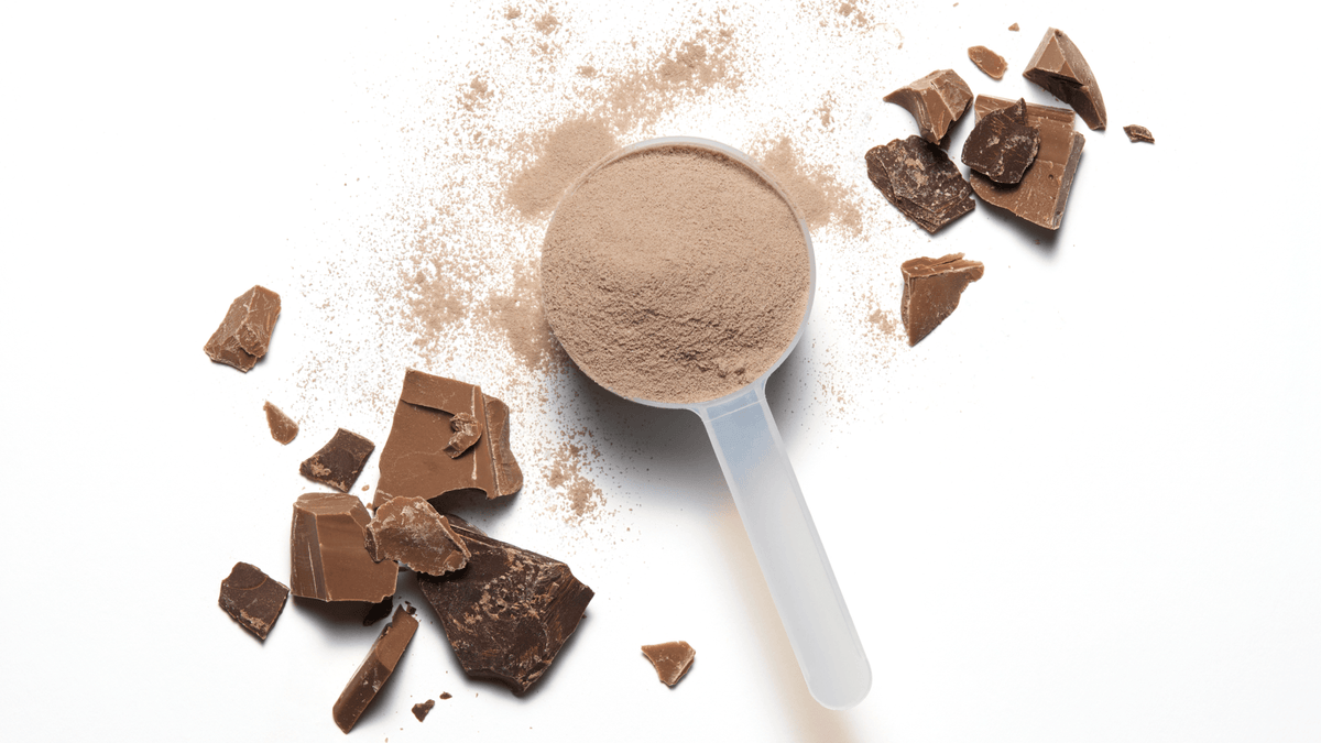 Scoop of NOBULL chocolate powder with chocolate pieces.