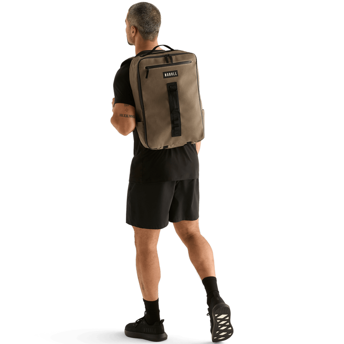 Man Wearing NOBULL Fallen Rock Waxed Backpack On Body Shot.