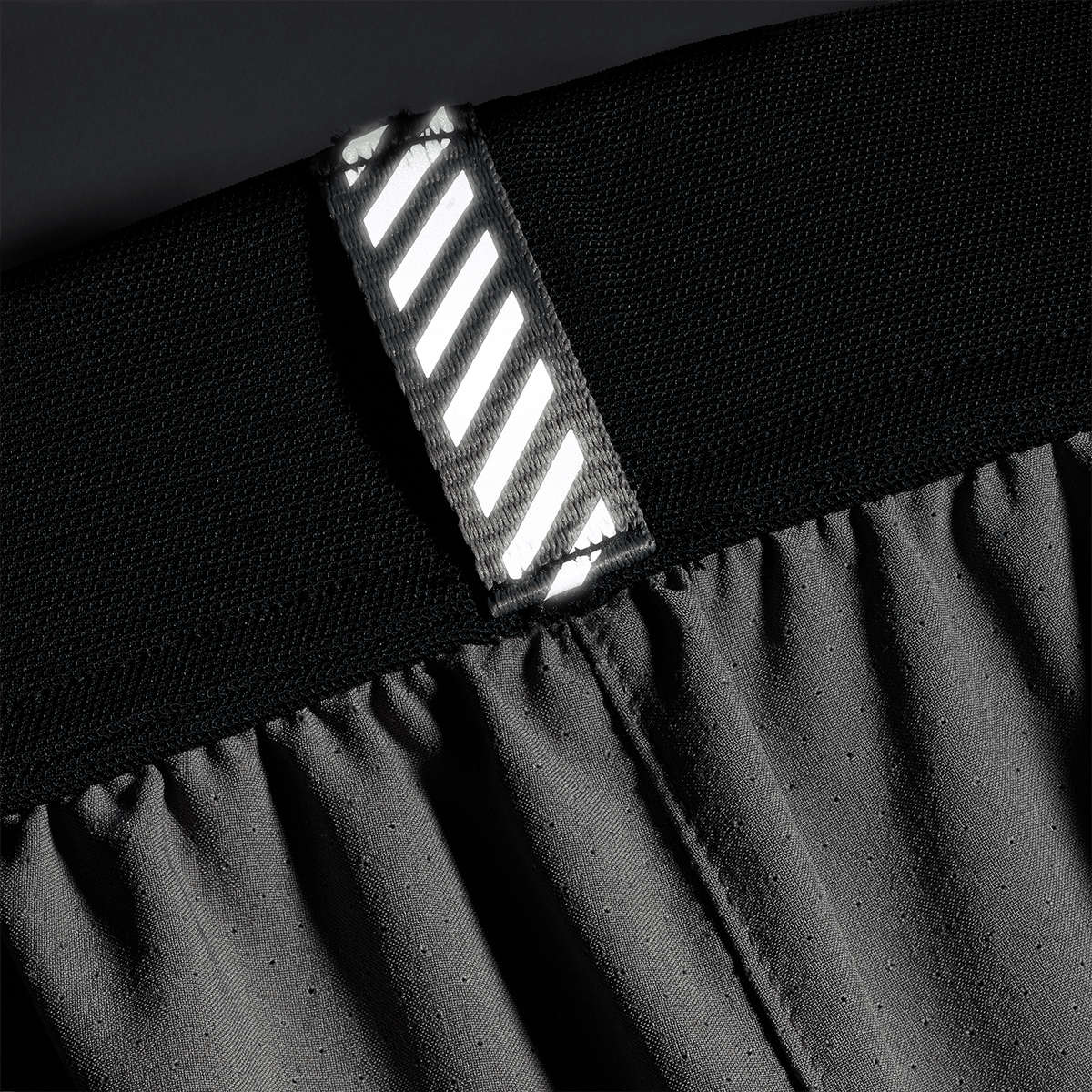 Men's Gargoyle Drive Short 6" (Unlined) Reflective Tab Detail Angle.