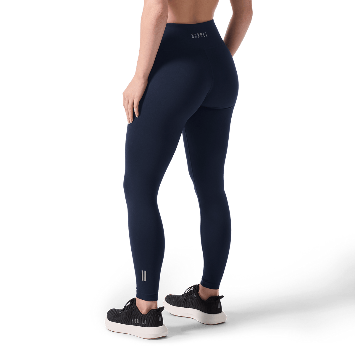 Women's Night Navy U High-Rise Matte Tight 28" Back Lower Body Angle.