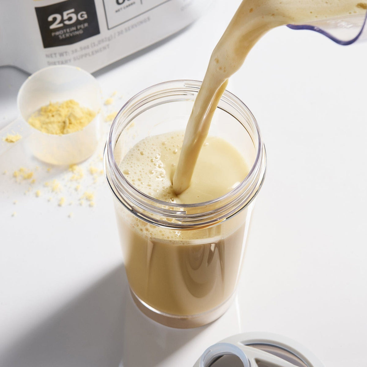 Vanilla Plant protein shake being poured into a glass